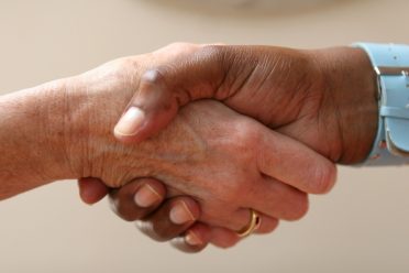 Two people shaking hands, agreeing about the contract or deal